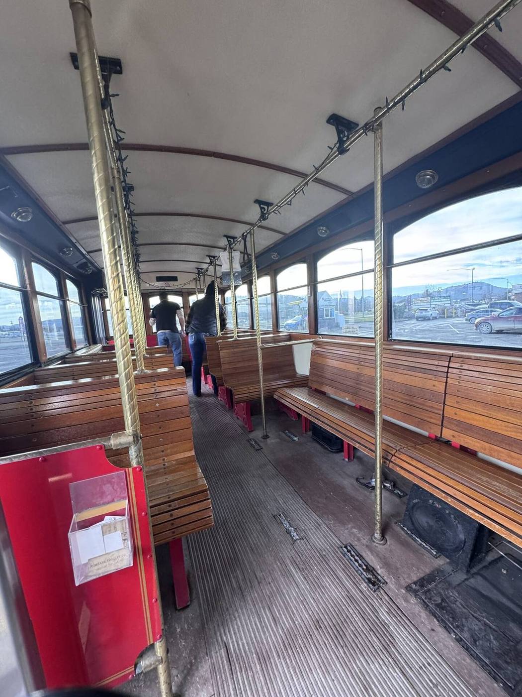 Oak seating, brass rails, and vintage interior of a Montana trolley